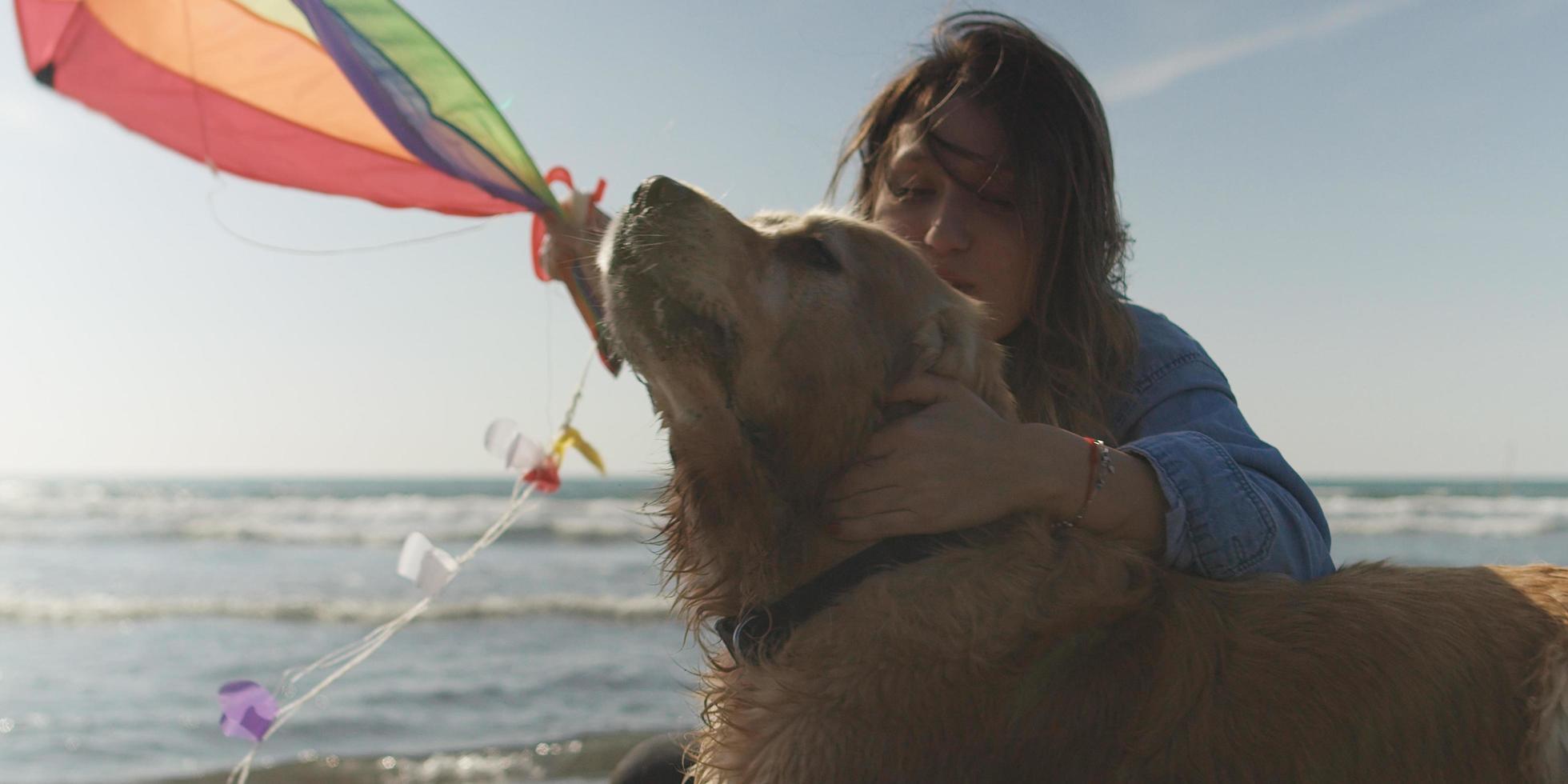 Woman holding kite at beach on autumn day photo