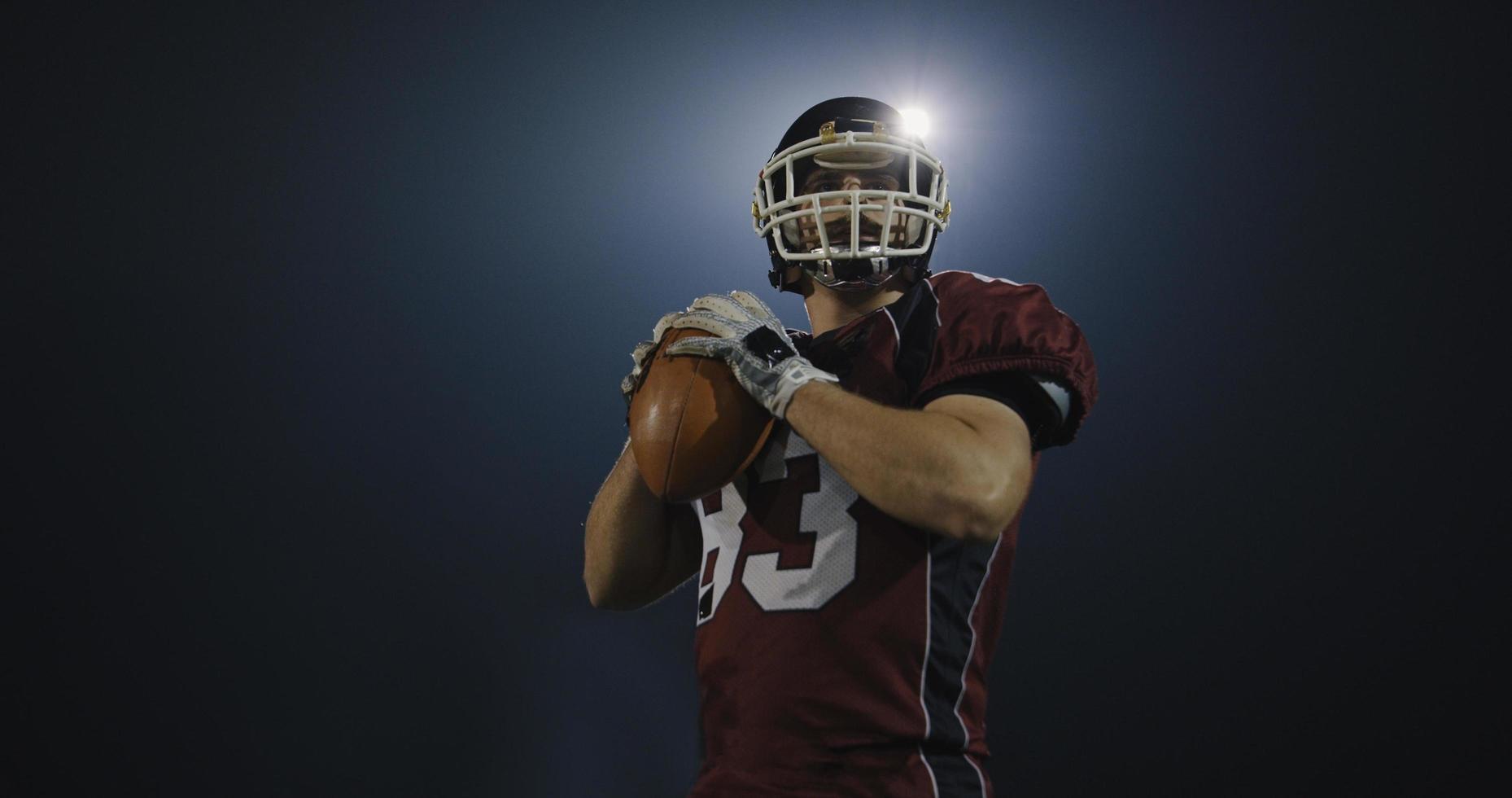 american football player throwing rugby ball photo