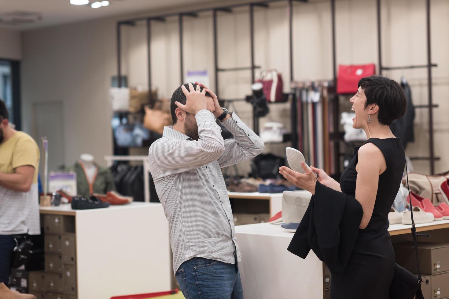 couple chooses shoes At Shoe Store photo