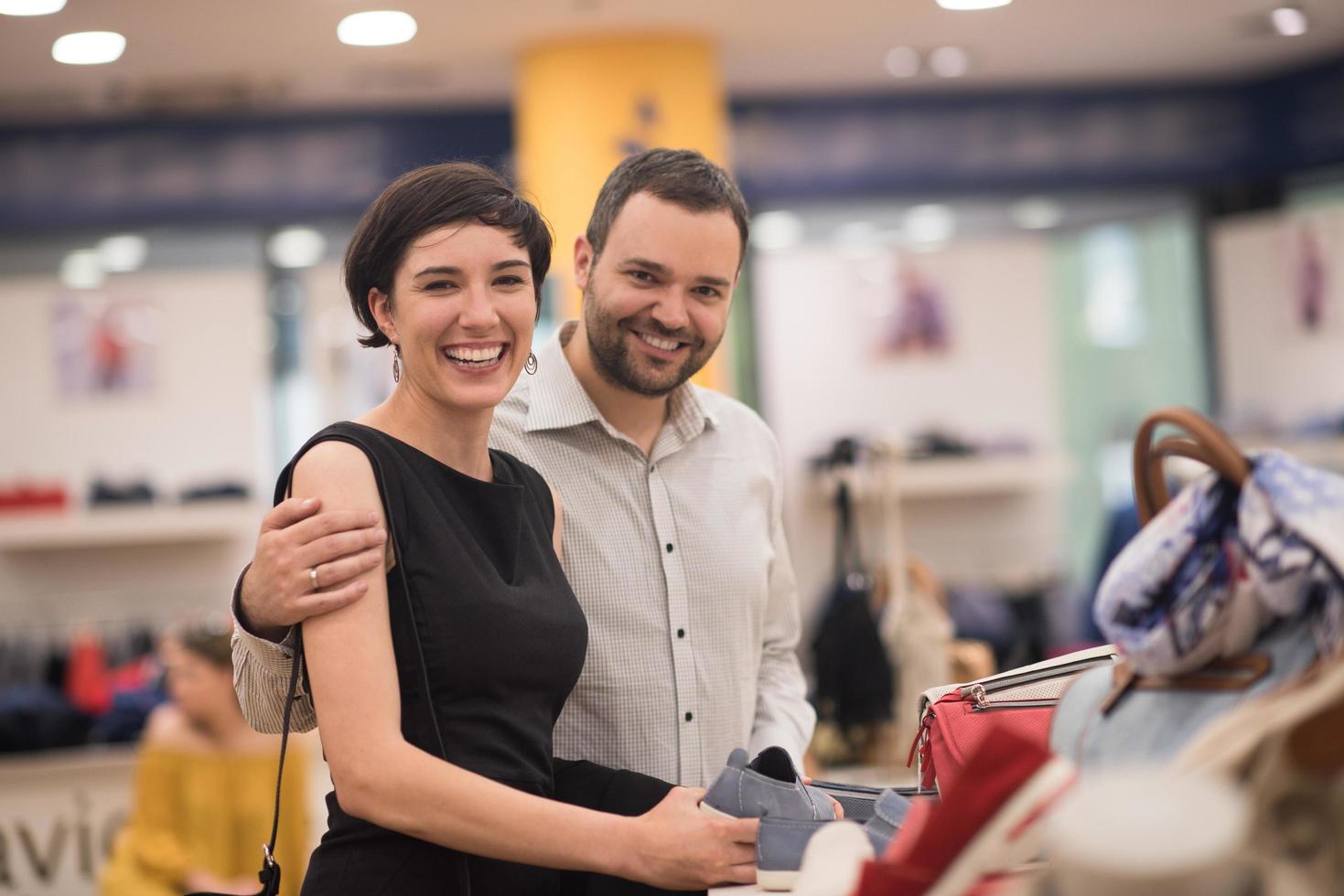 couple chooses shoes At Shoe Store photo