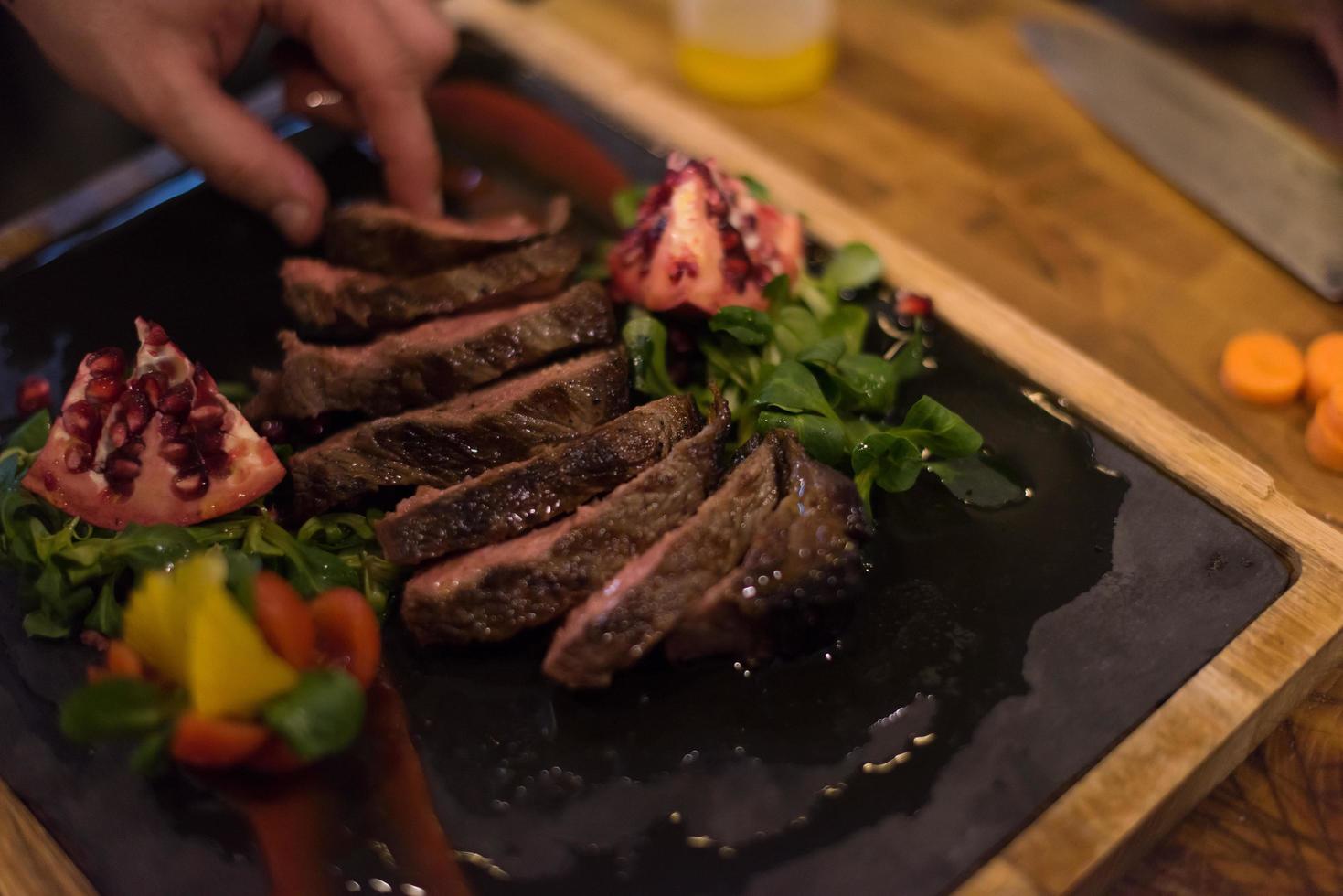 closeup of Chef hands preparing beef steak photo