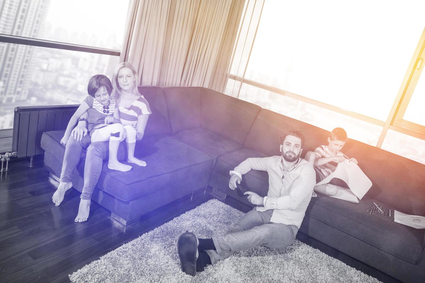 Happy Young Family Playing Together on sofa photo