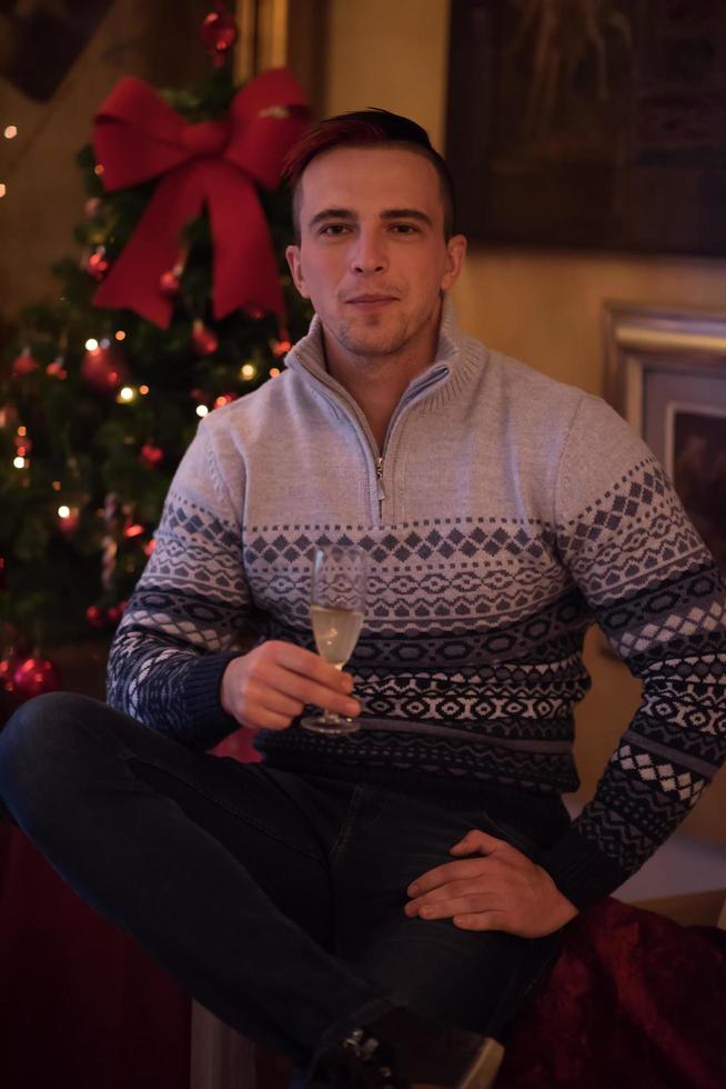 Happy young man with a glass of champagne photo