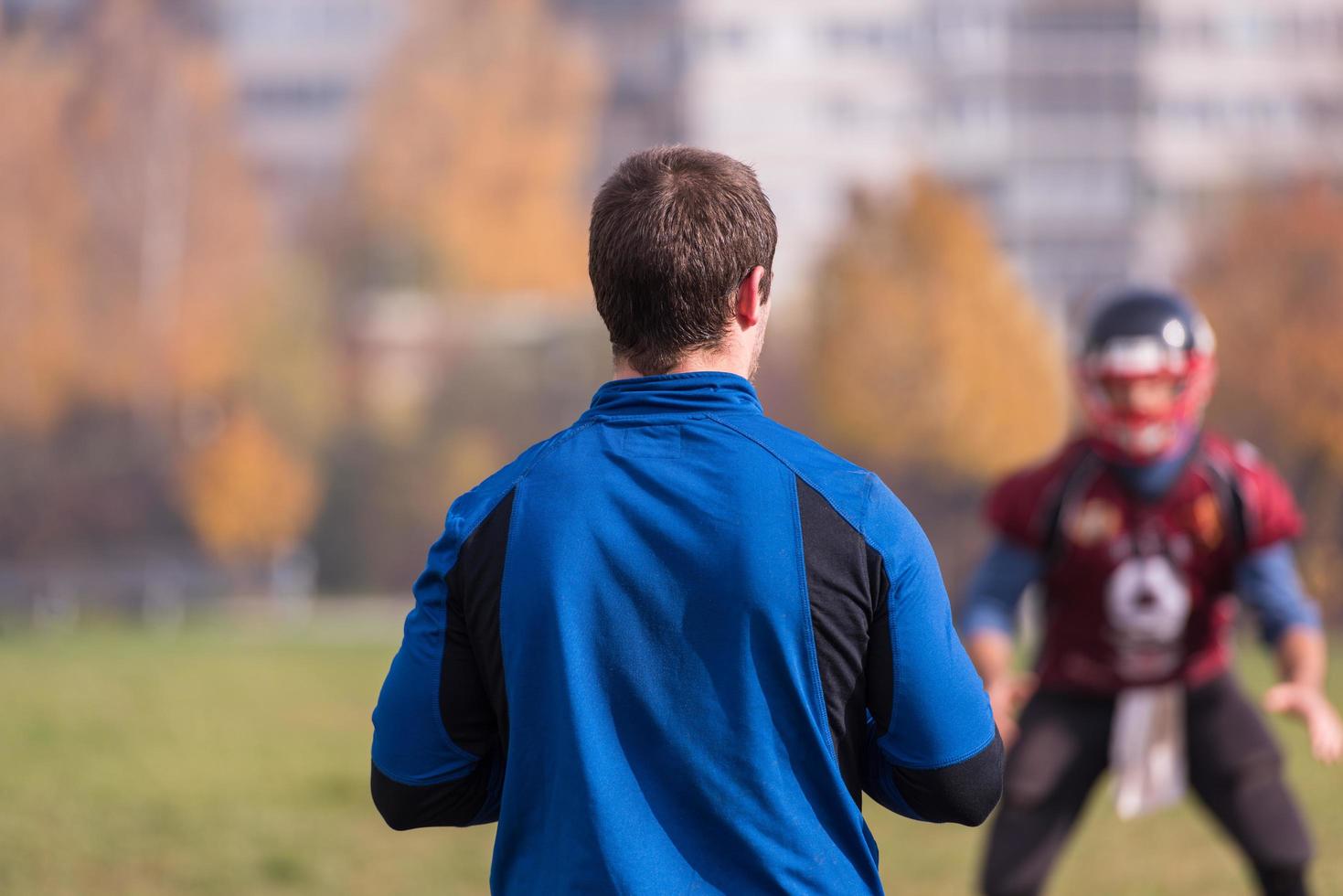 american football team with coach in action photo