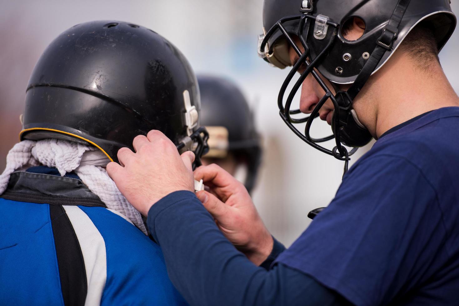 American football players checking helmets photo