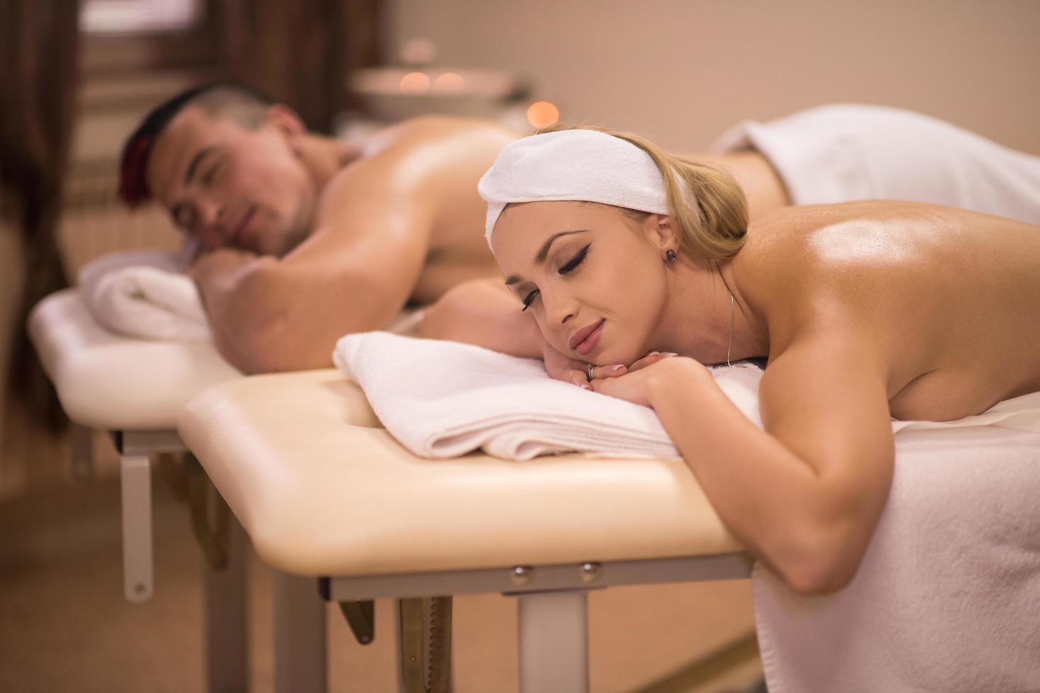 young couple lying on massage table photo