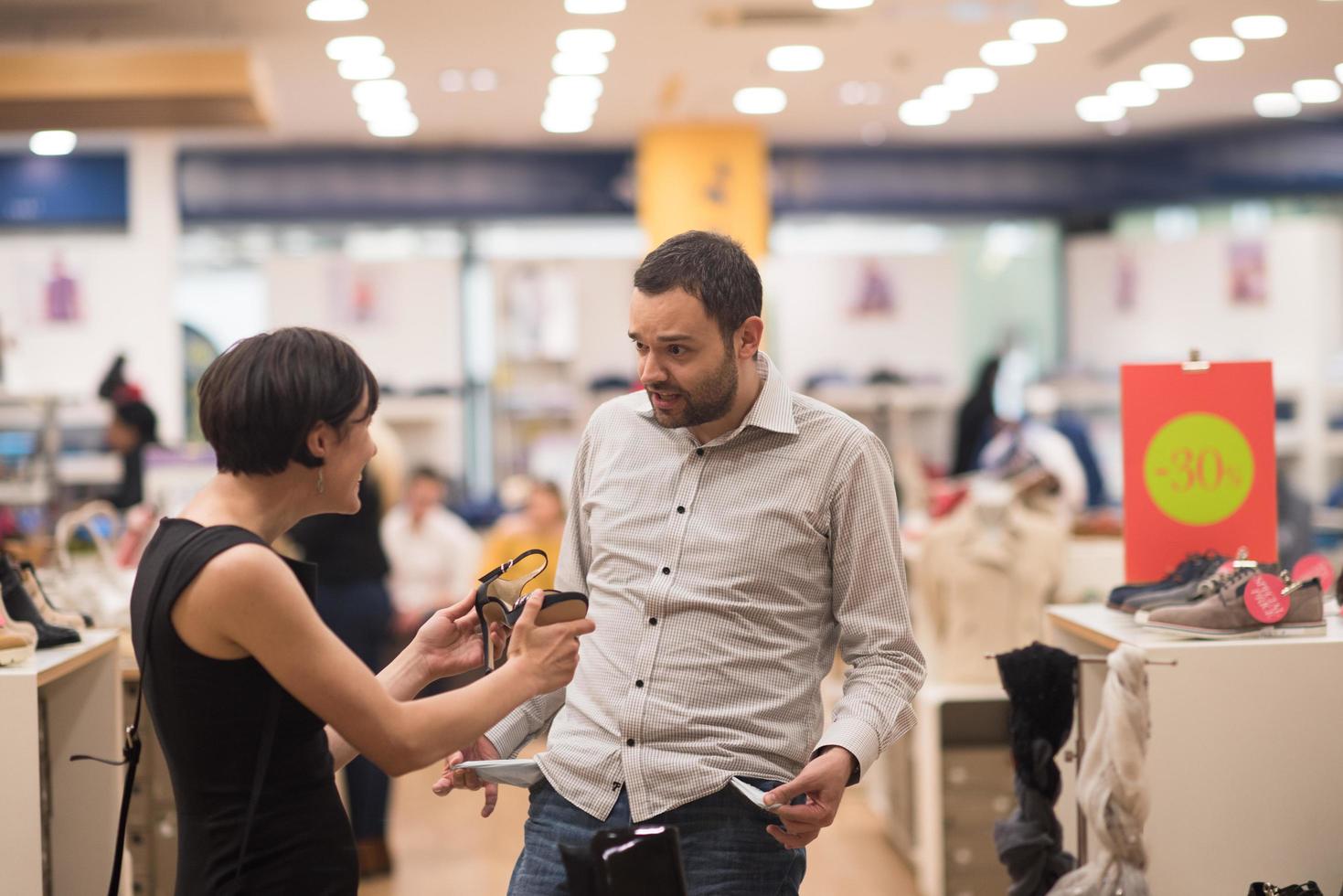 couple chooses shoes At Shoe Store photo