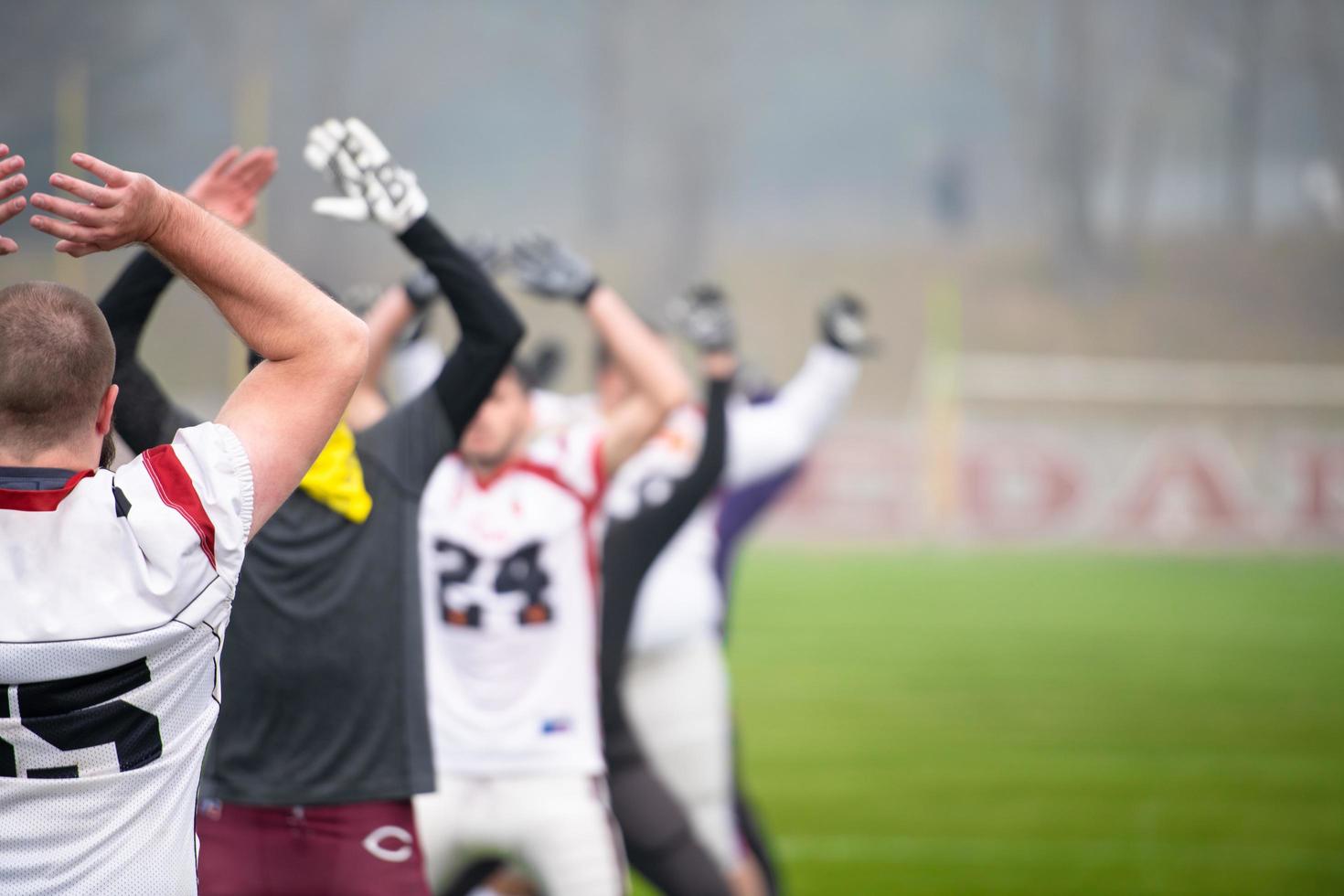 american football players stretching and warming up photo