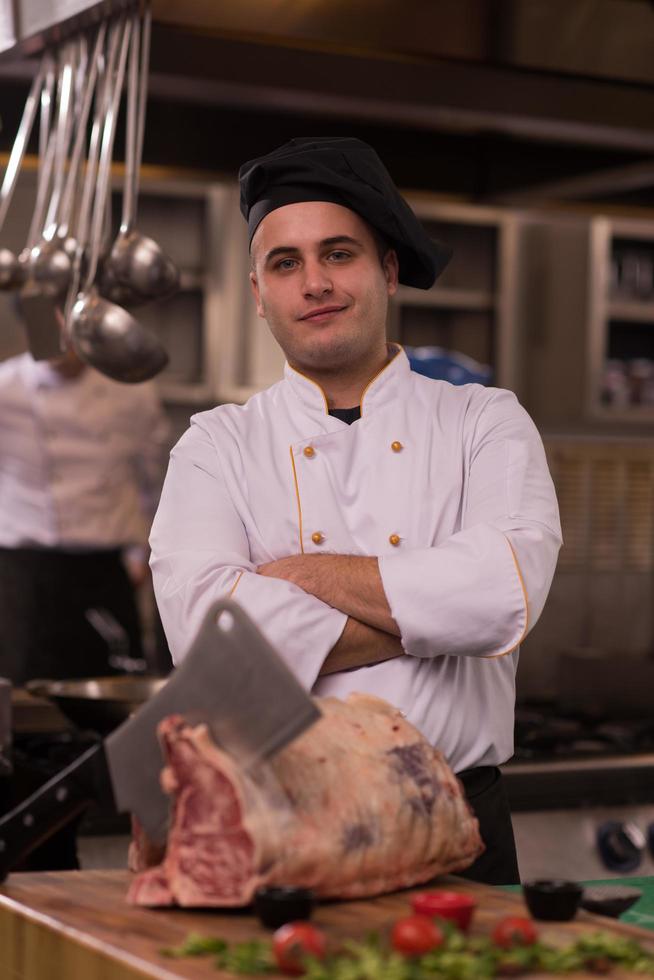 chef cutting big piece of beef photo