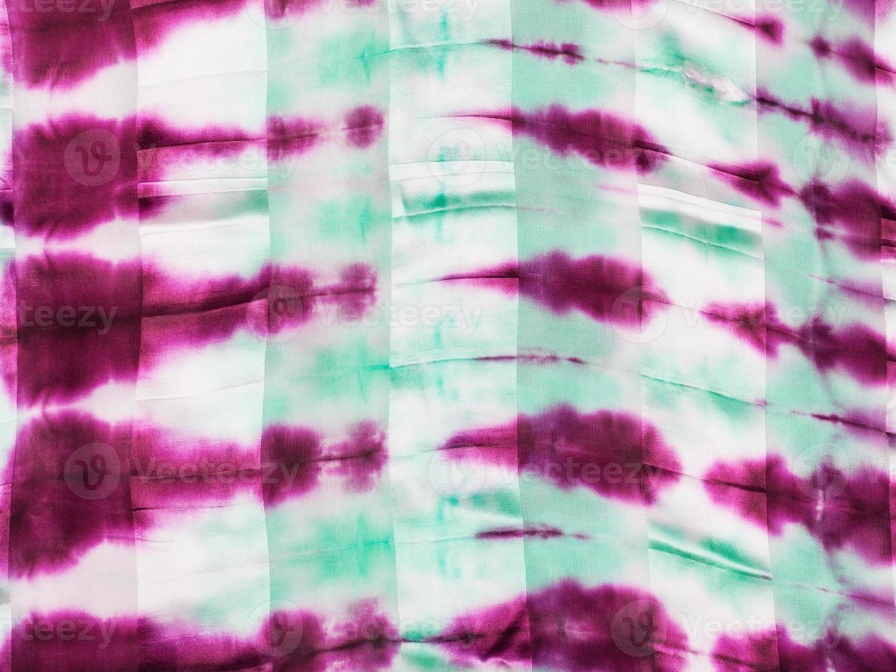 abstract magenta and green spots on silk batik photo