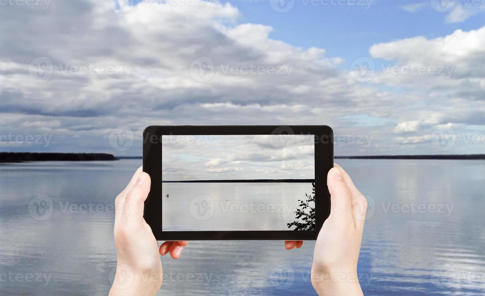 tourist taking photo of Lake Seliger, Russia