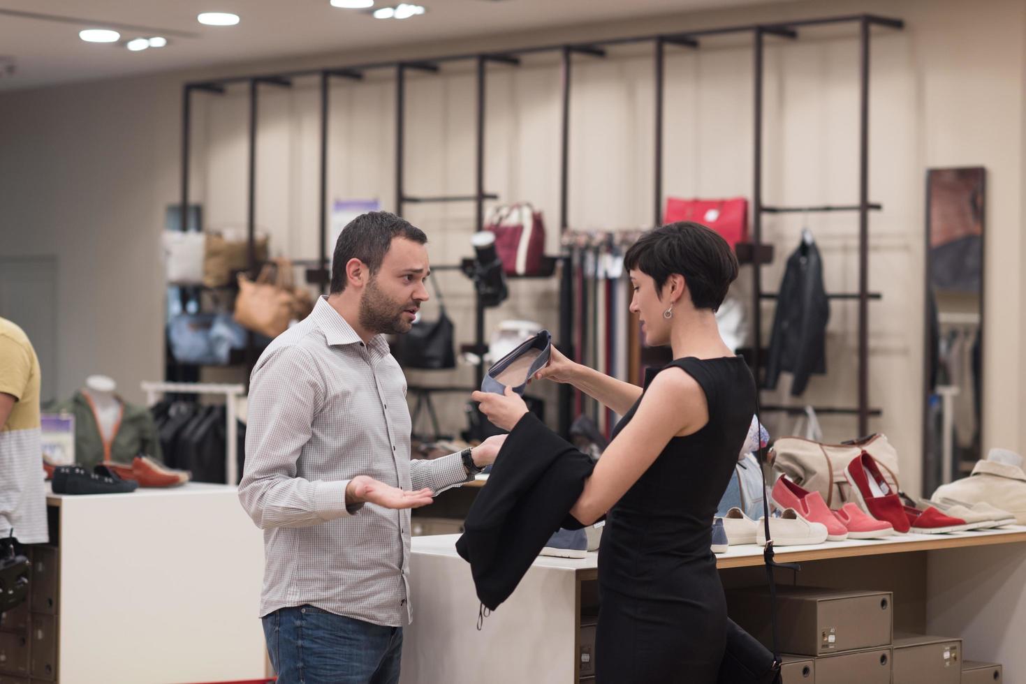 couple chooses shoes At Shoe Store photo