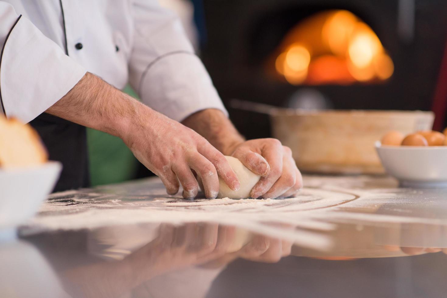 chef hands preparing dough for pizza photo