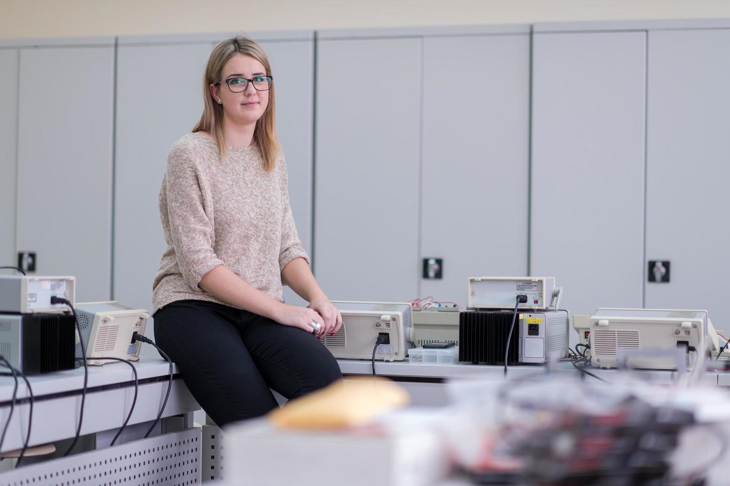 female student sitting on the table photo