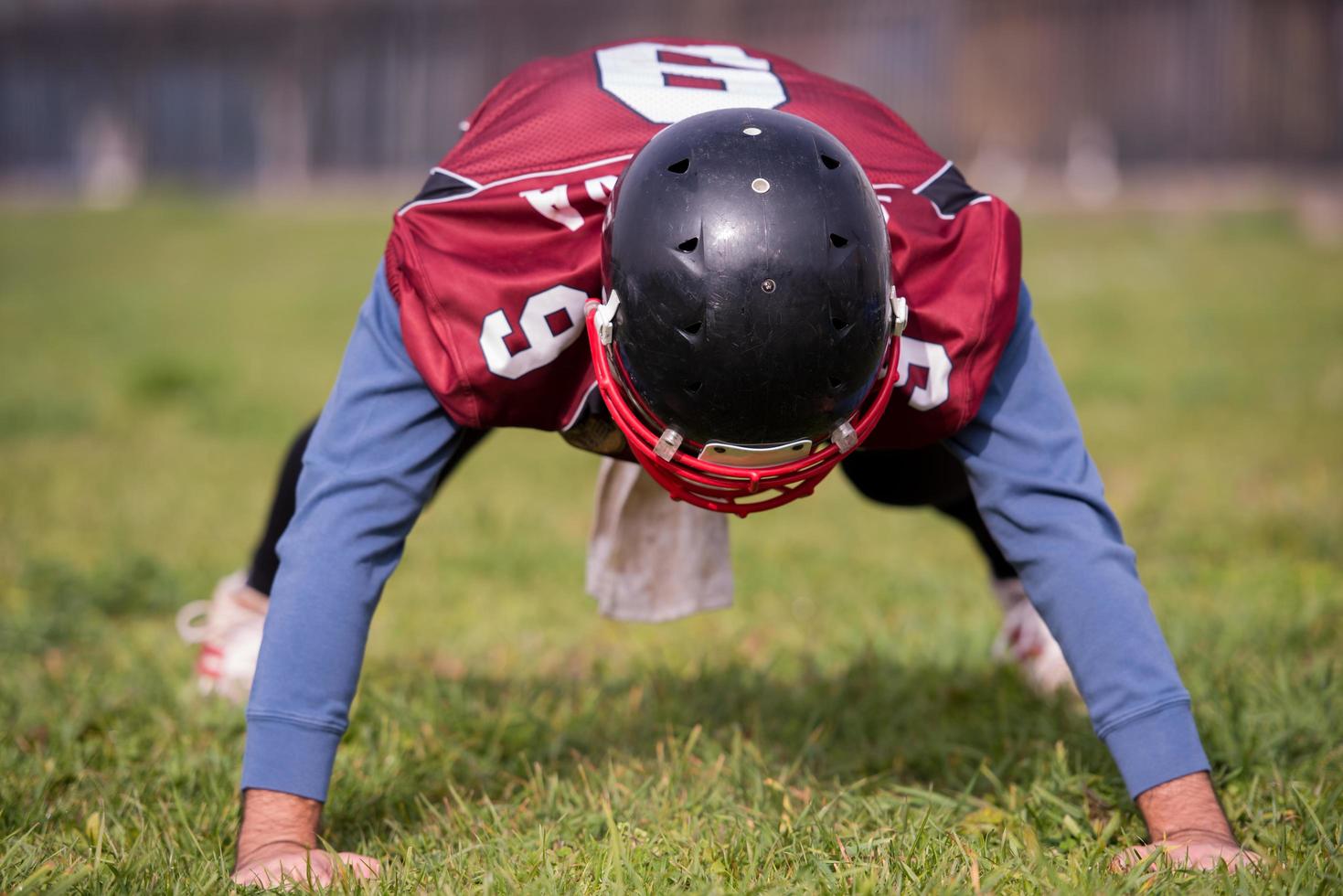 american football player doing push ups photo