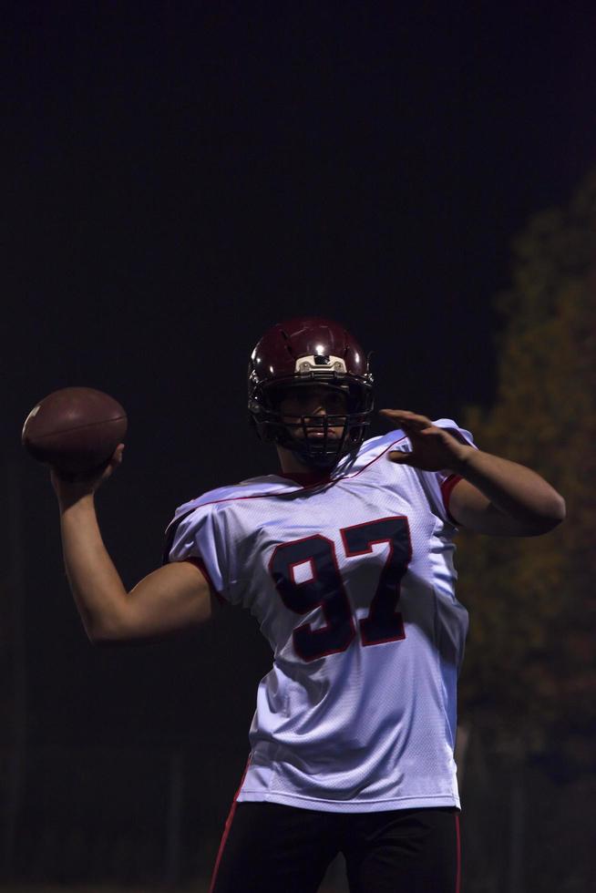 american football player throwing rugby ball photo