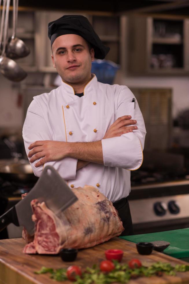 chef cutting big piece of beef photo