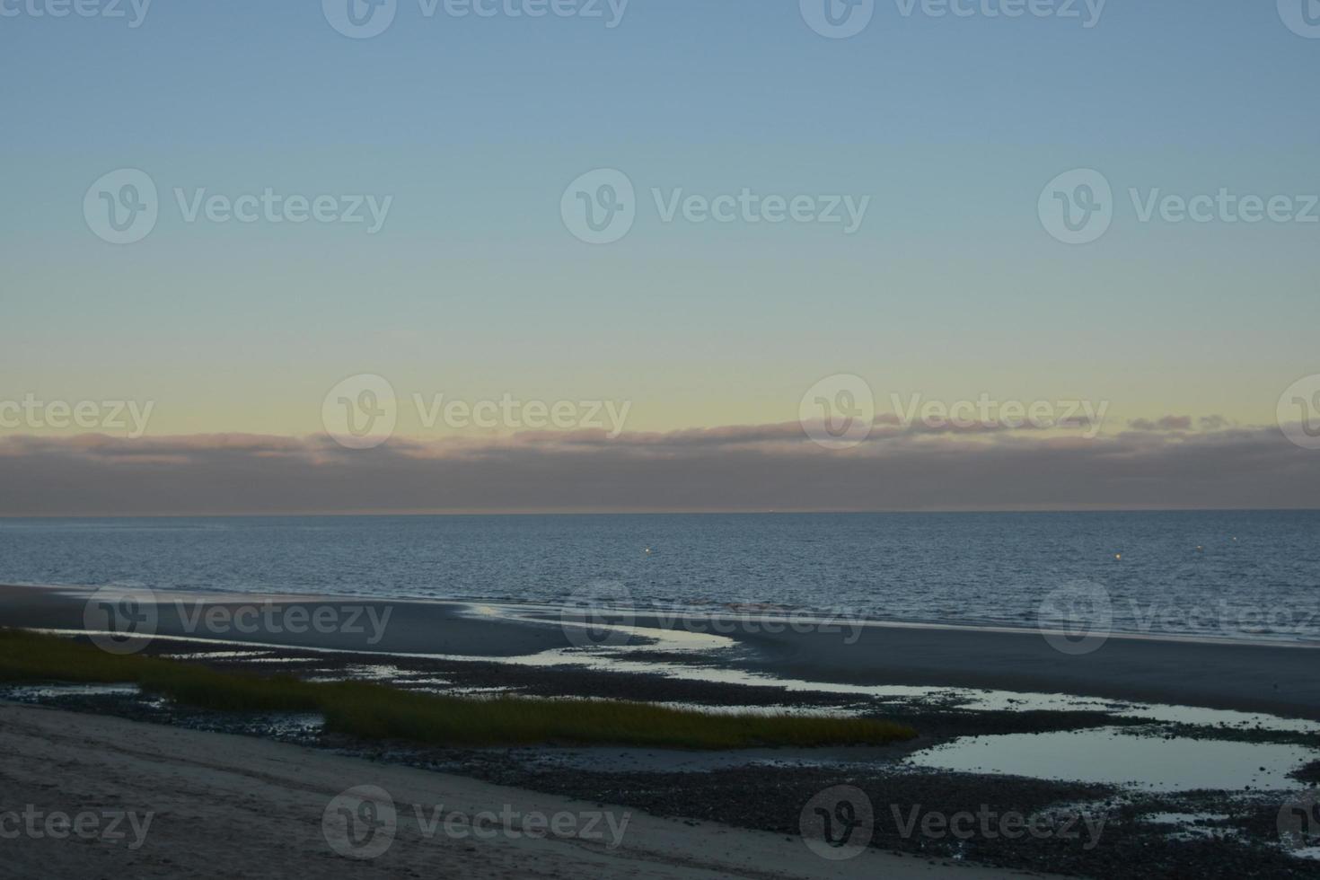 Stunning beach on the coast of cape cod during a sunset photo