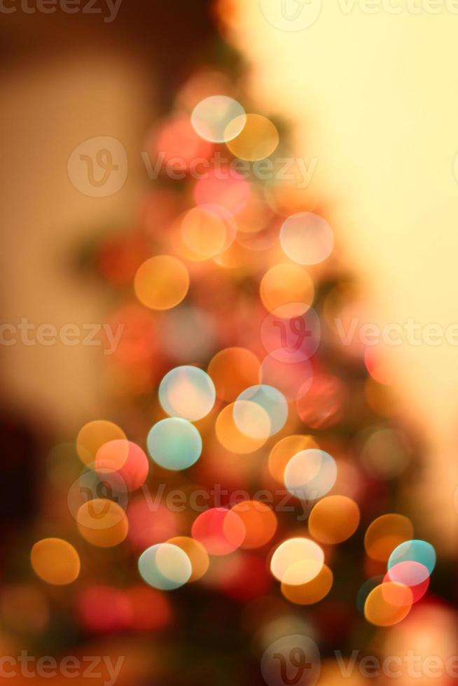 Christmas lights on xmas tree defocused. Holiday bokeh background photo