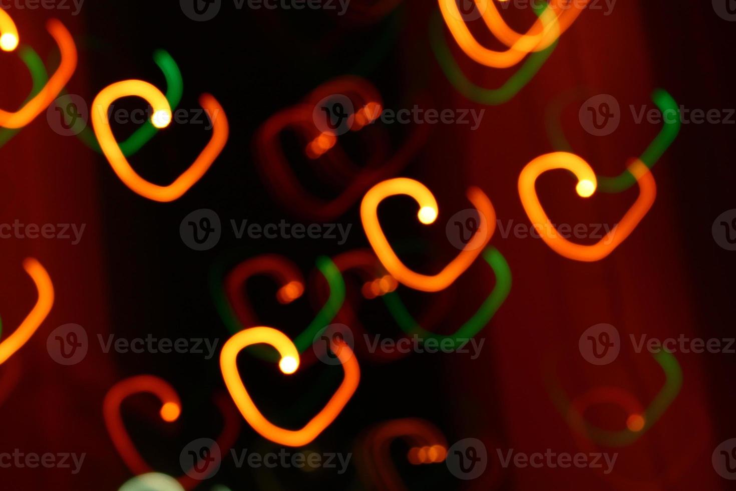 abstract heart bokeh orange lights on dark background photo