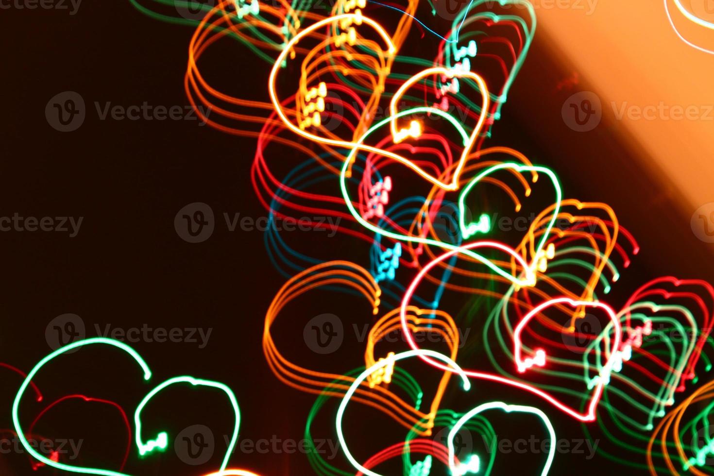 blurred abstract christmas lights lines on black background photo