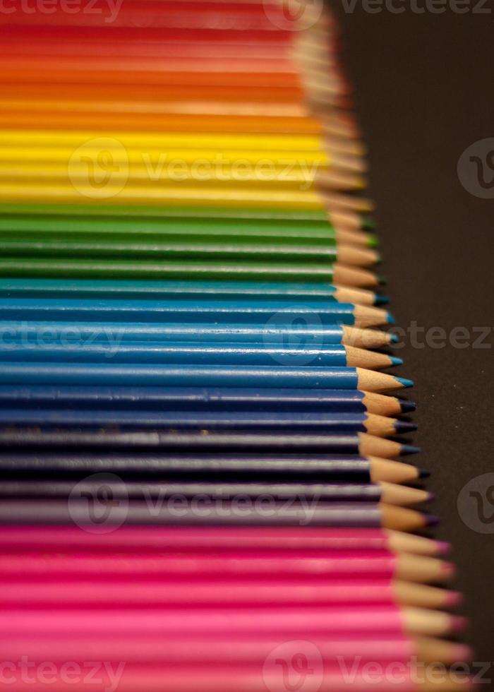 colorful rainbow pencils row gradient on black background photo