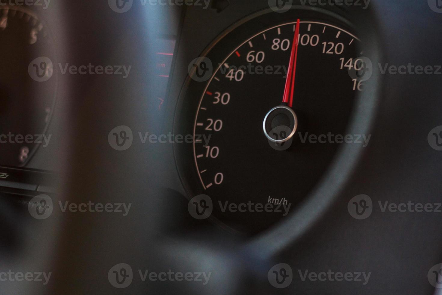 high speed on speedometer in automobile on dark background photo