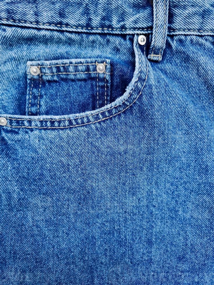 Blue denim Jeans pocket with revits texture background photo