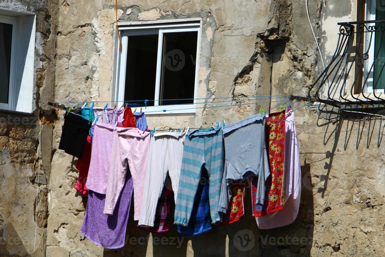 Washed clothes and linen dries on the balcony. photo
