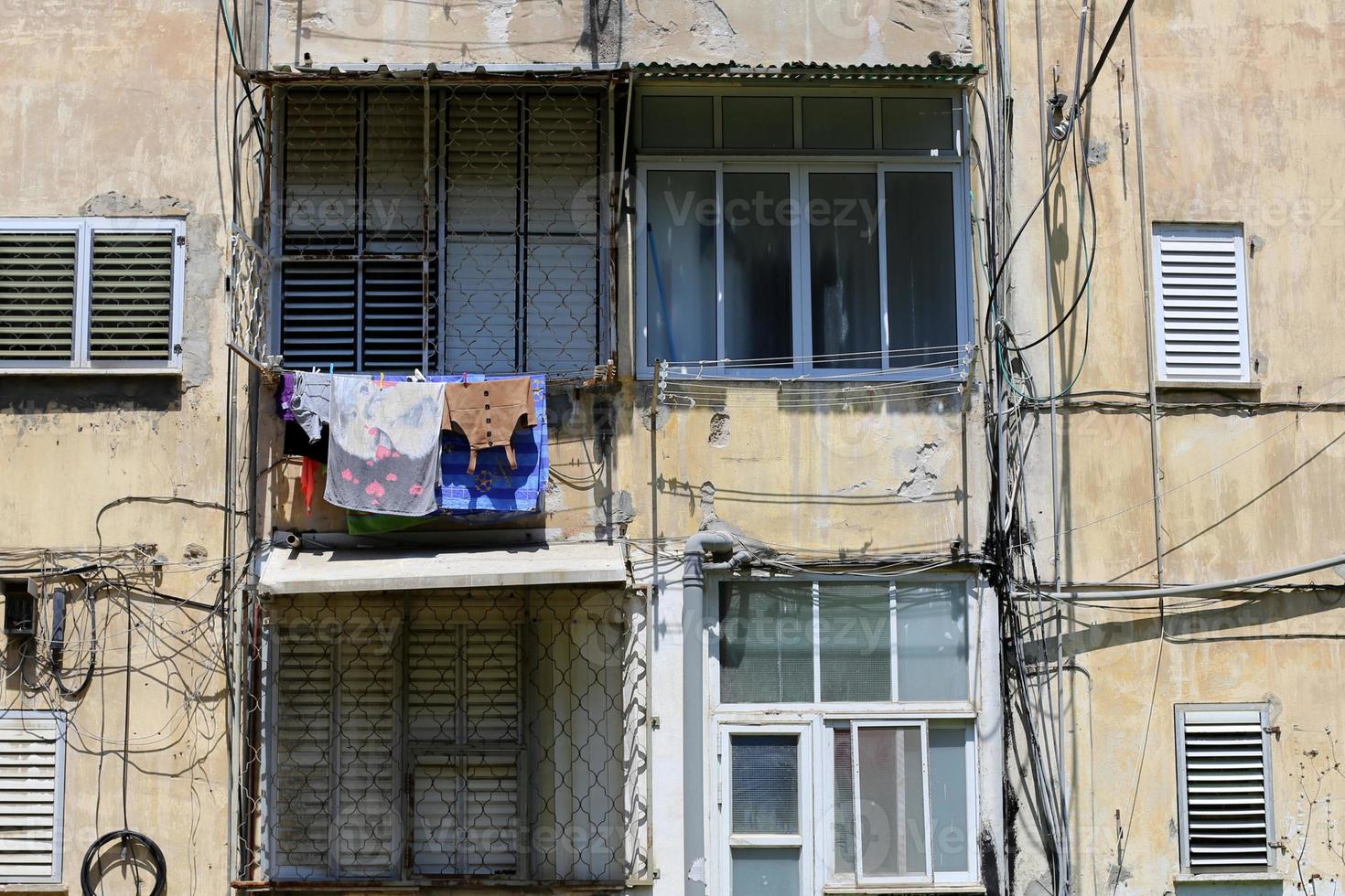 Washed clothes and linen dries on the balcony. photo
