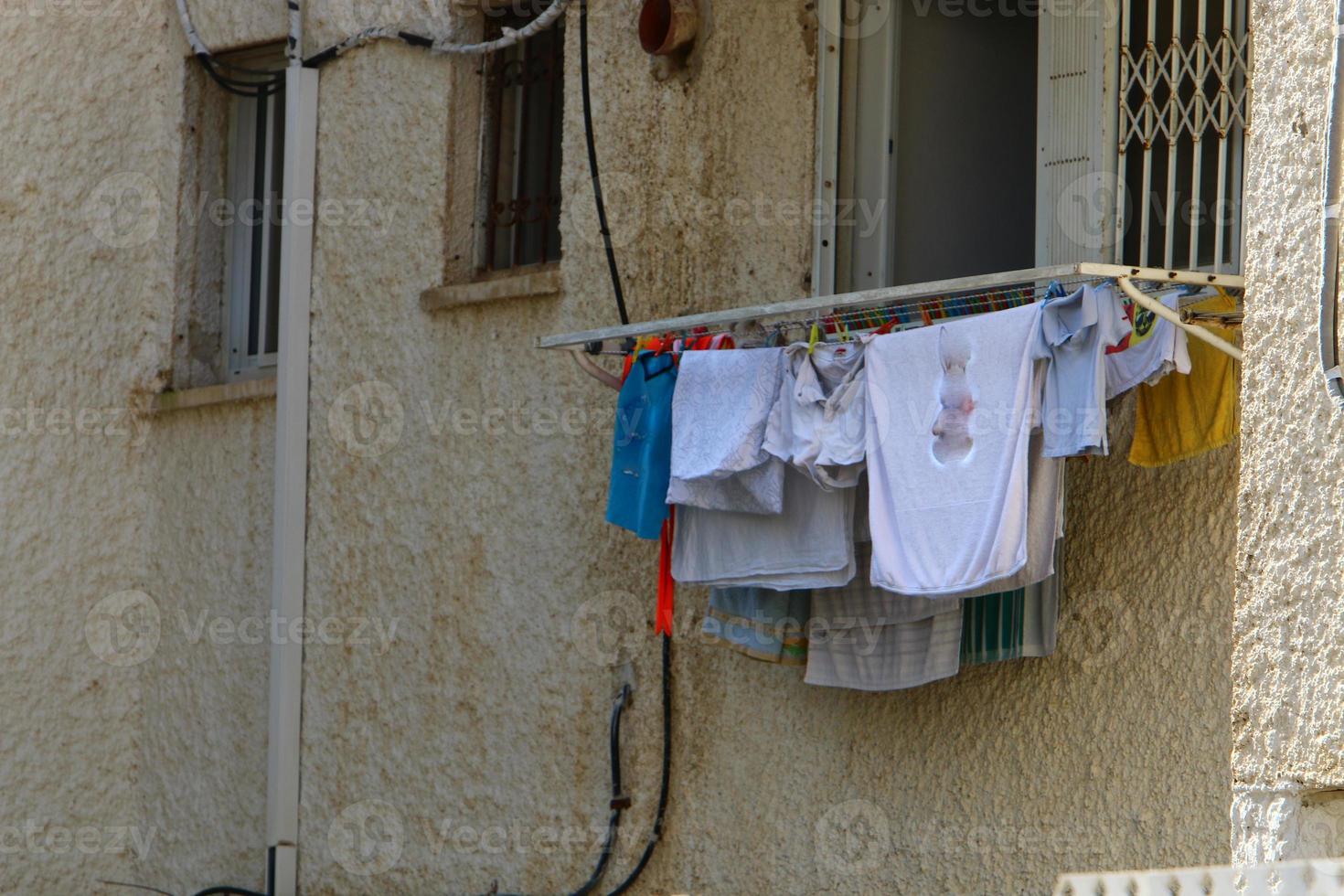 Washed clothes and linen dries on the balcony. photo