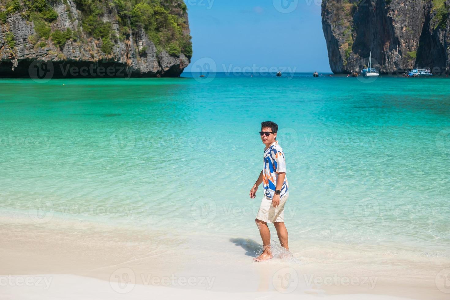 happy tourist man at Maya Bay beach on Phi Phi island, Krabi, Thailand. landmark, destination Southeast Asia Travel, vacation and holiday concept photo