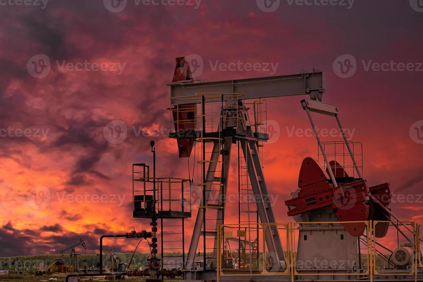 plataforma de perforación de petróleo y gato de bomba al fondo del atardecer. foto