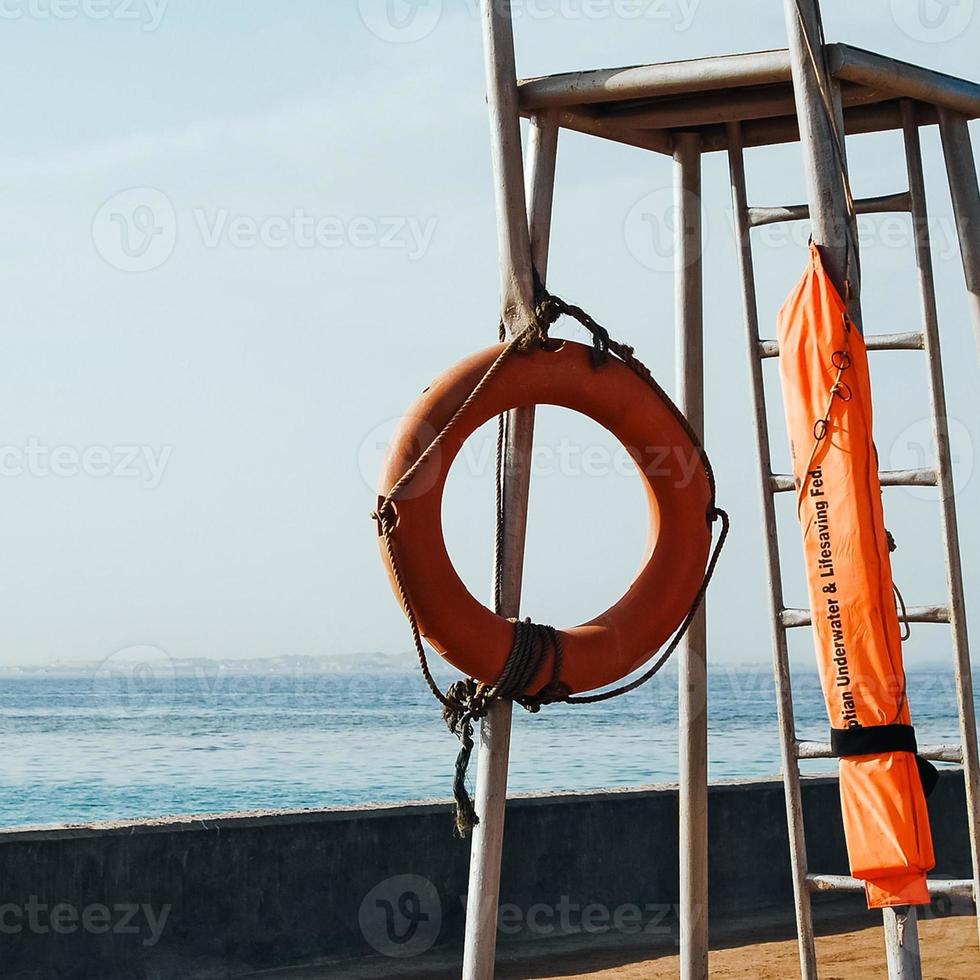 Lifebuoy on lifeguard watchtower on the beach photo