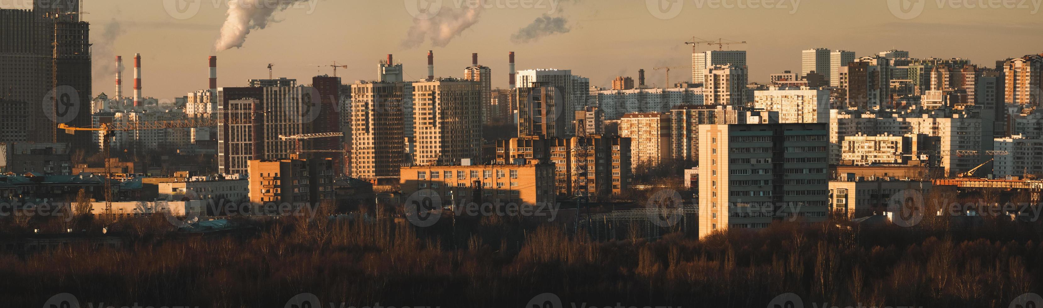 City skyline with smoking plant chimneys, cityscape panorama photo