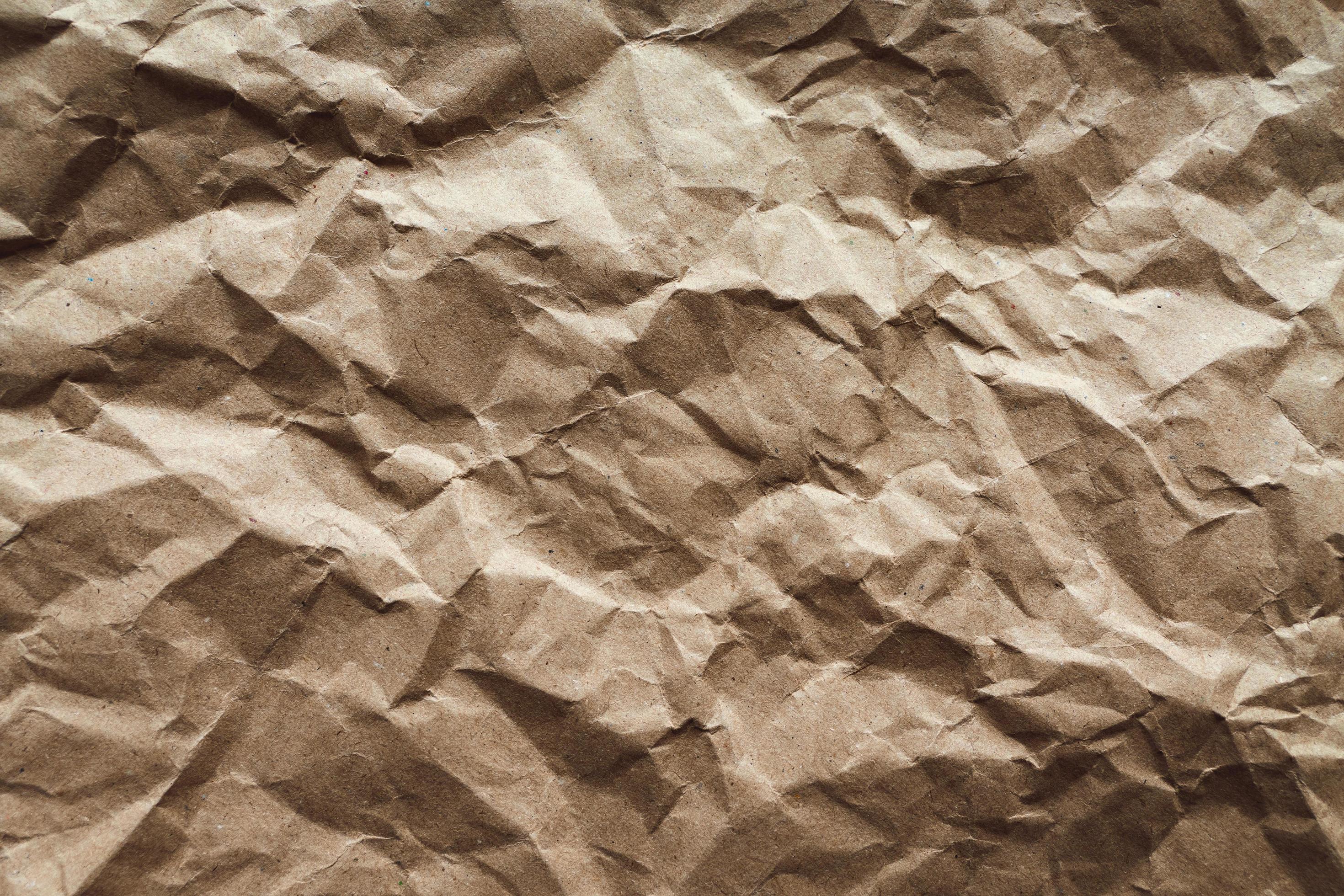 Crumpled paper texture, brown recycled paper abstract background