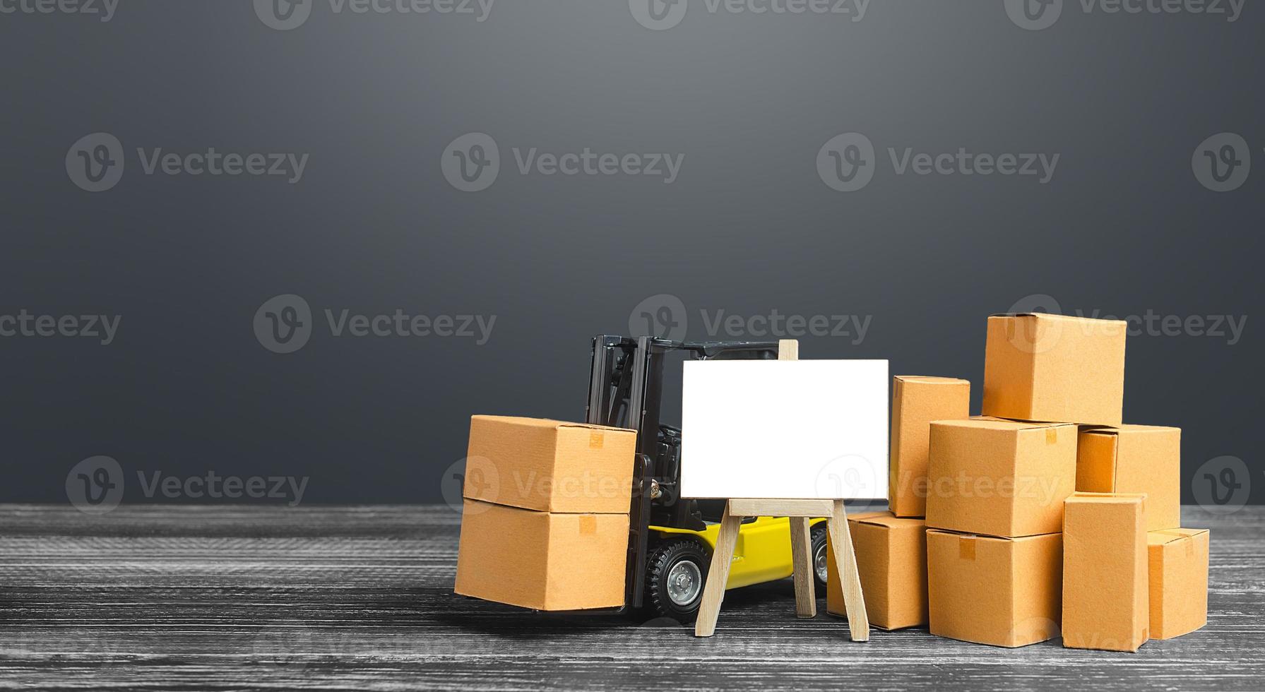 Forklift with boxes and blank easel sign. Warehousing concept and logistics transportation of goods and products. Economy, industry infrastructure. Sale trade. Import and export. Delivery and shipment photo