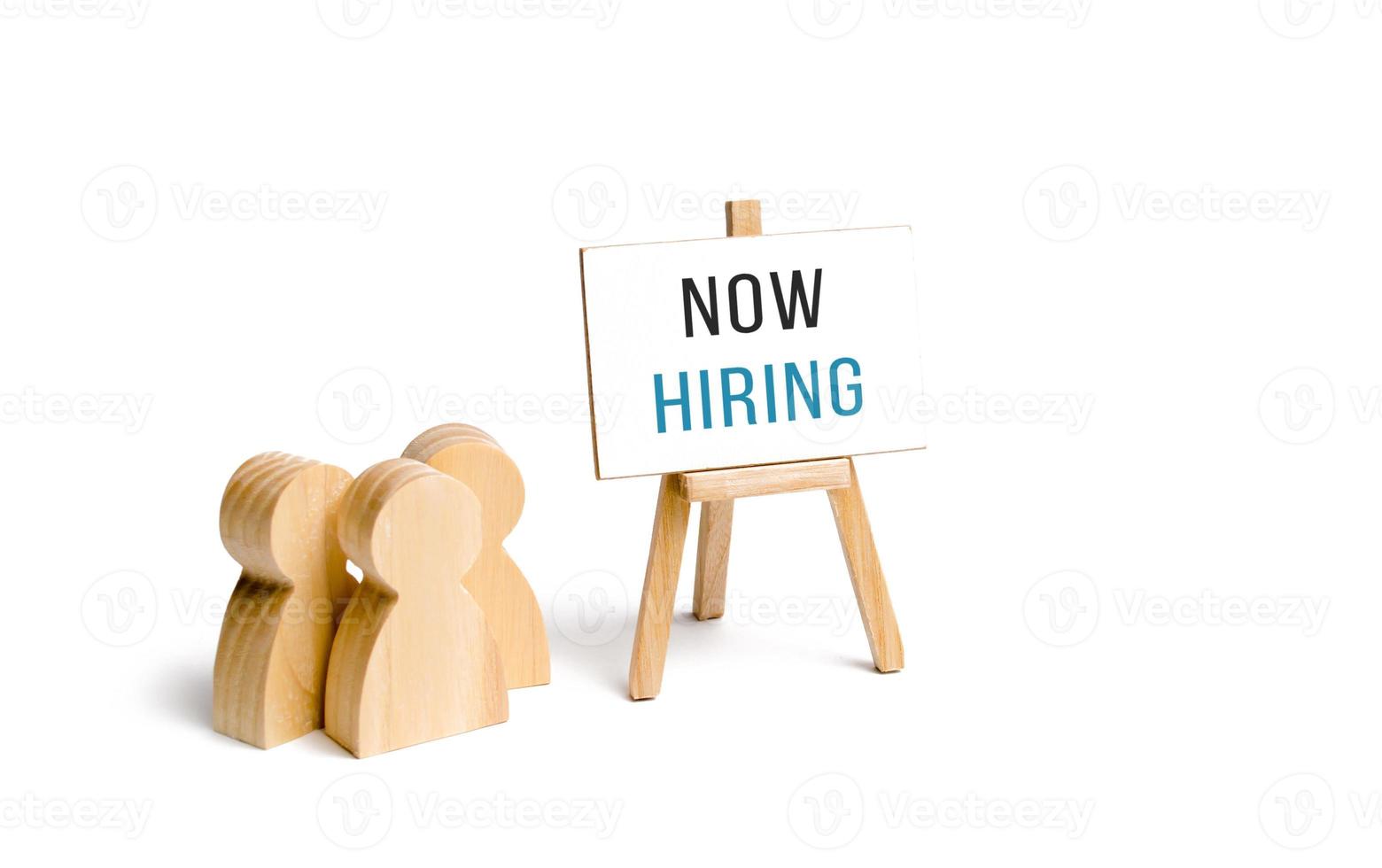 People group with a Now Hiring sign. Hire staff. Employment agency. Staffing. Search and recruitment of new employees for work. Human resources. Team building, teamwork cooperation. photo