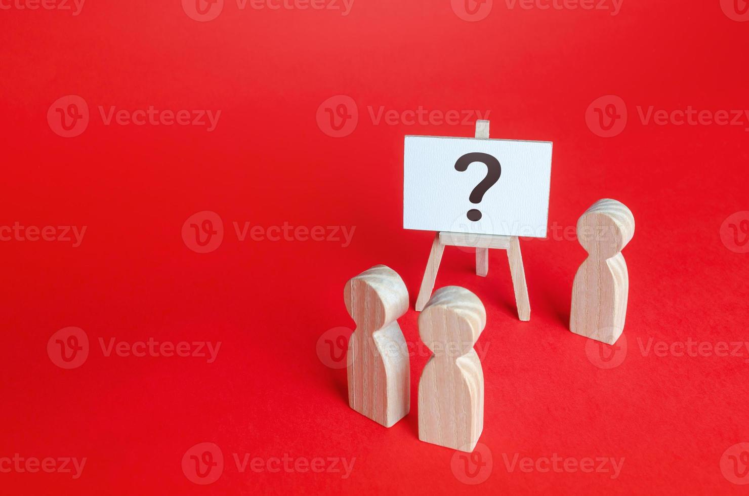 People are standing near the easel with a question mark. Asking questions, searching for truth. Curiosity, learn and improve. mystery, investigation research. Survey. Announcement of event, surprise. photo