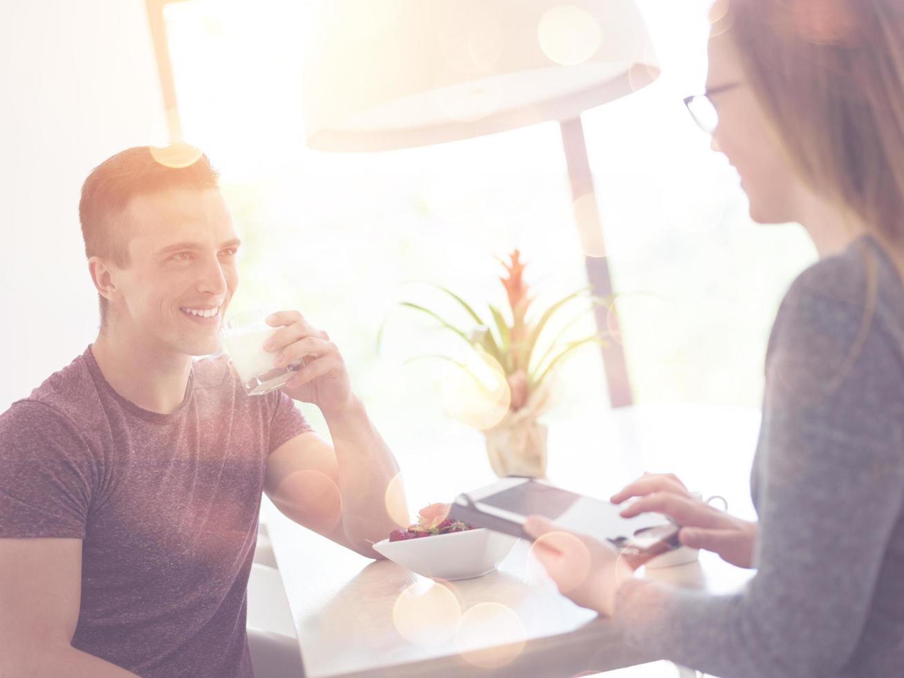 couple enjoying morning coffee and strawberries photo
