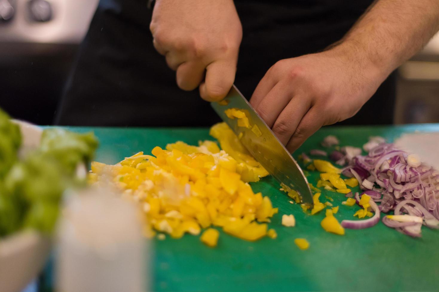 Chef cutting fresh and delicious vegetables photo