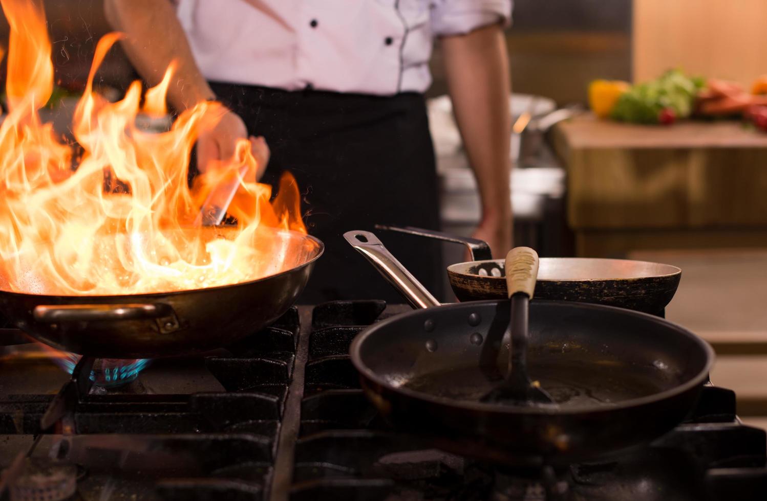 Chef doing flambe on food photo