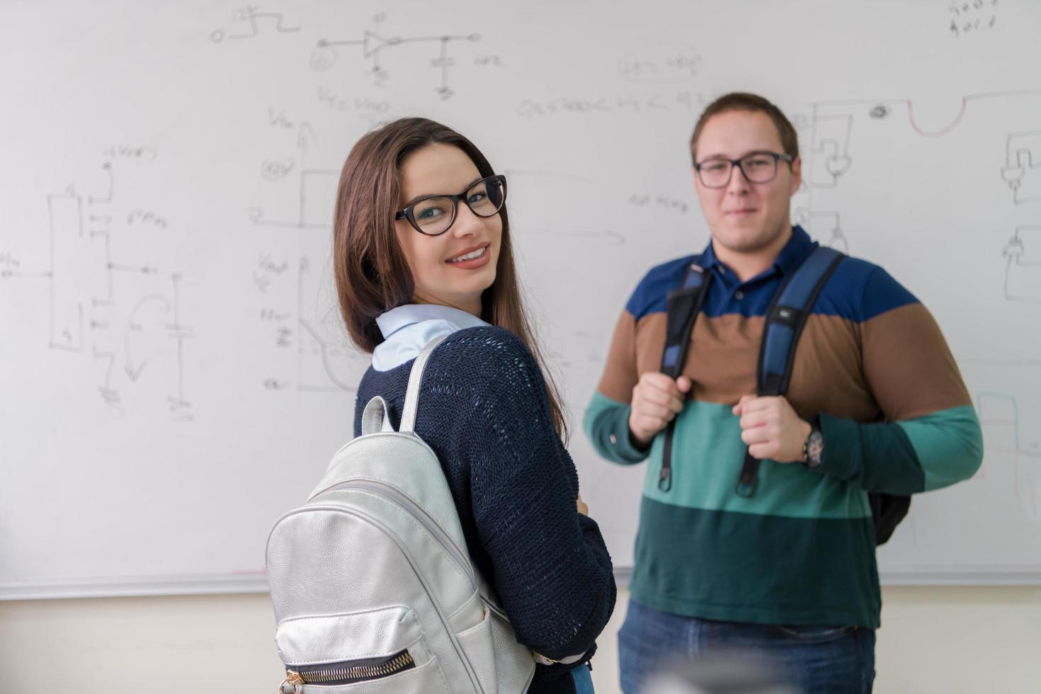 portrait of young students in front of chalkboard photo