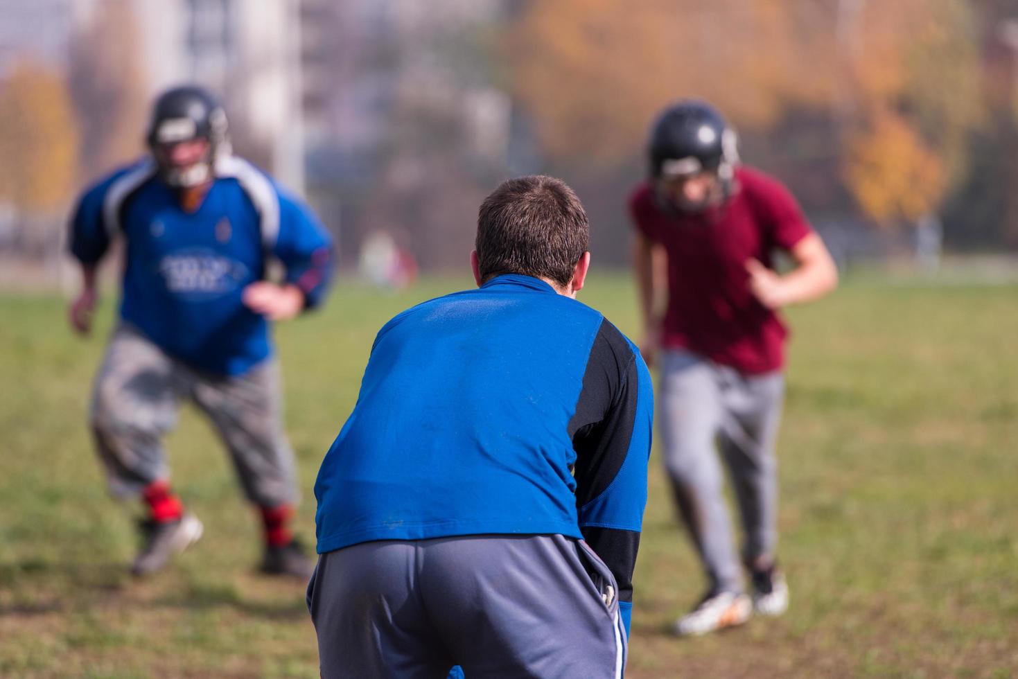 american football team with coach in action photo