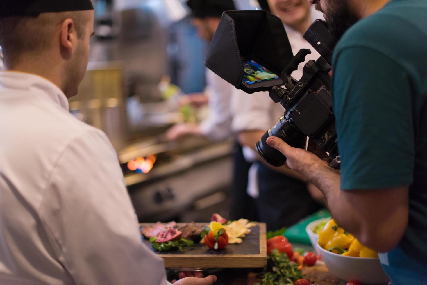 videographer recording while team cooks and chefs preparing meal photo