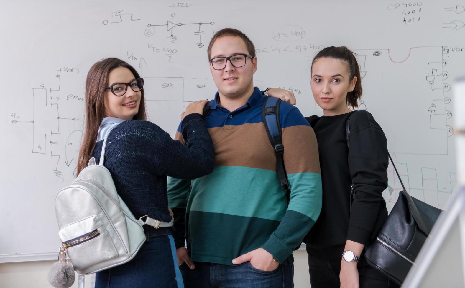 portrait of young students in front of chalkboard photo