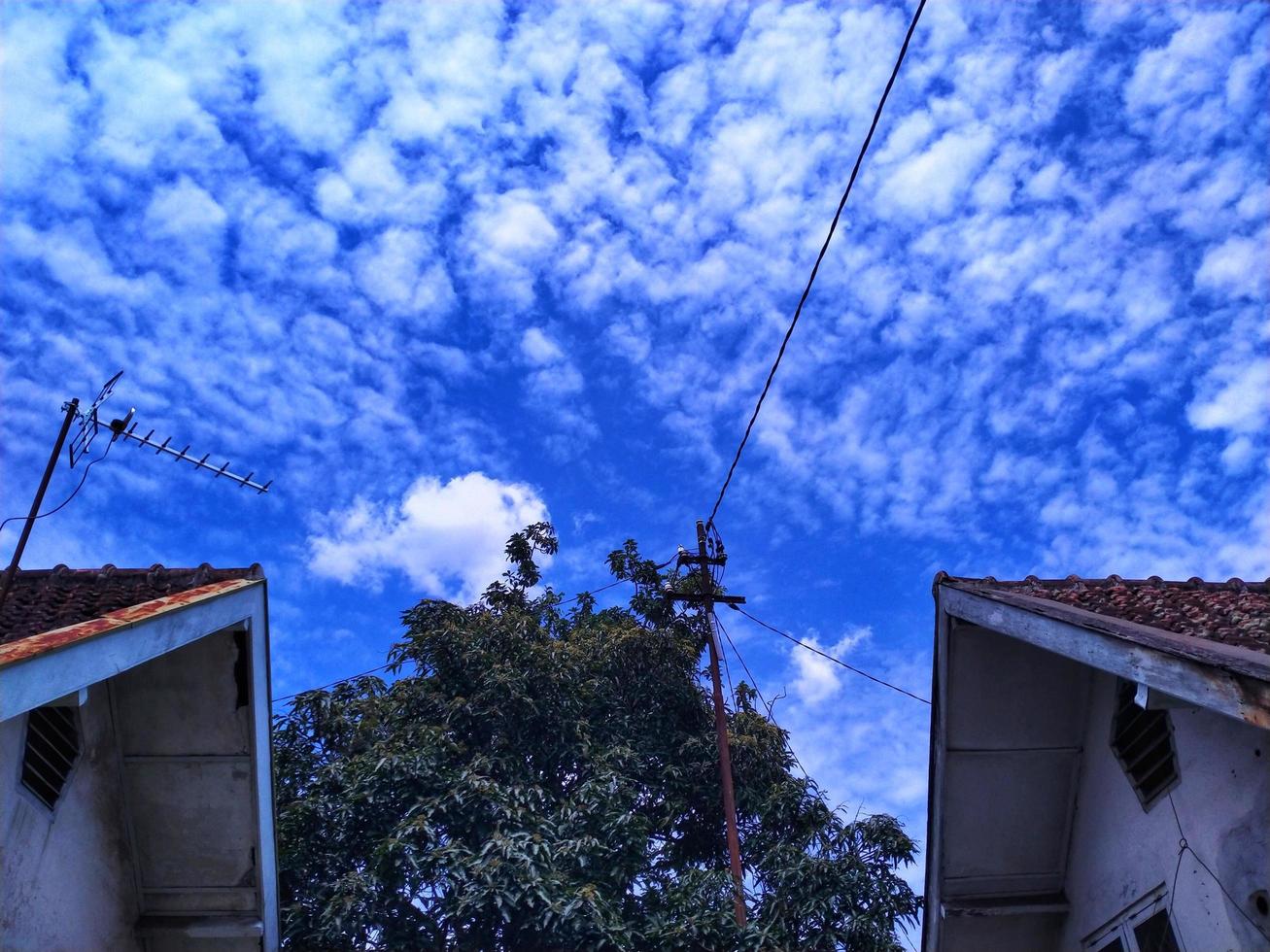 the roof of the house and the bright blue sky photo