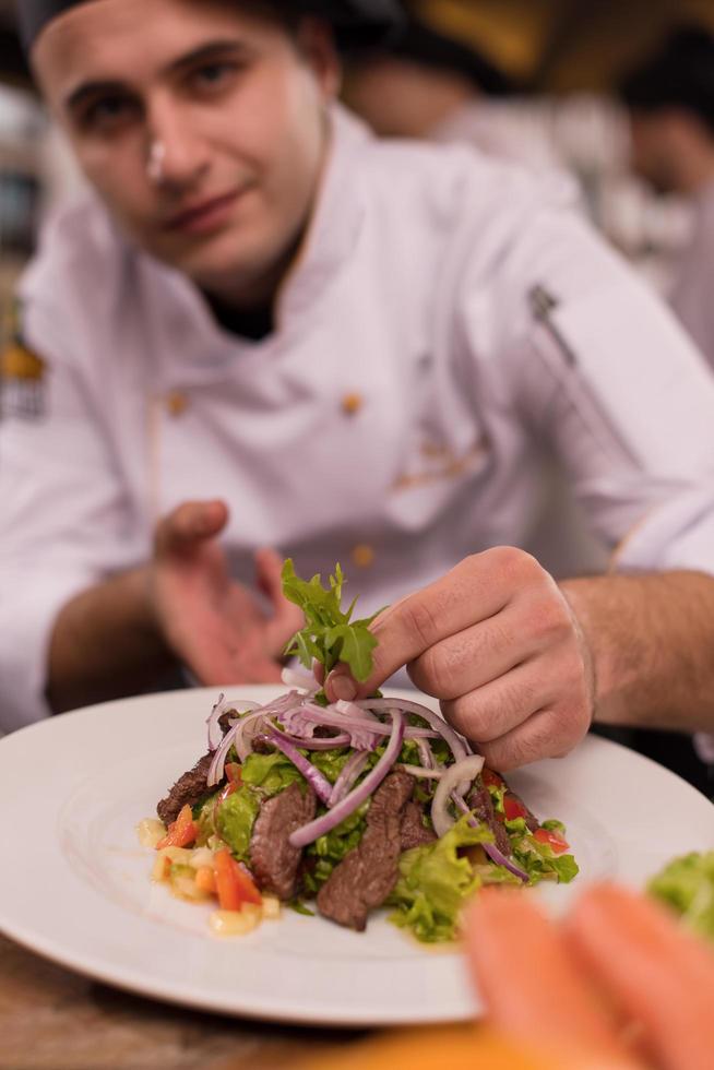 cook chef decorating garnishing prepared meal photo