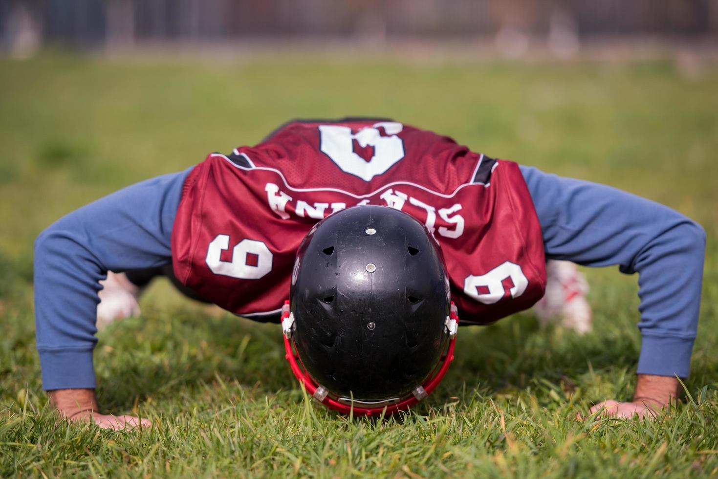 american football player doing push ups photo