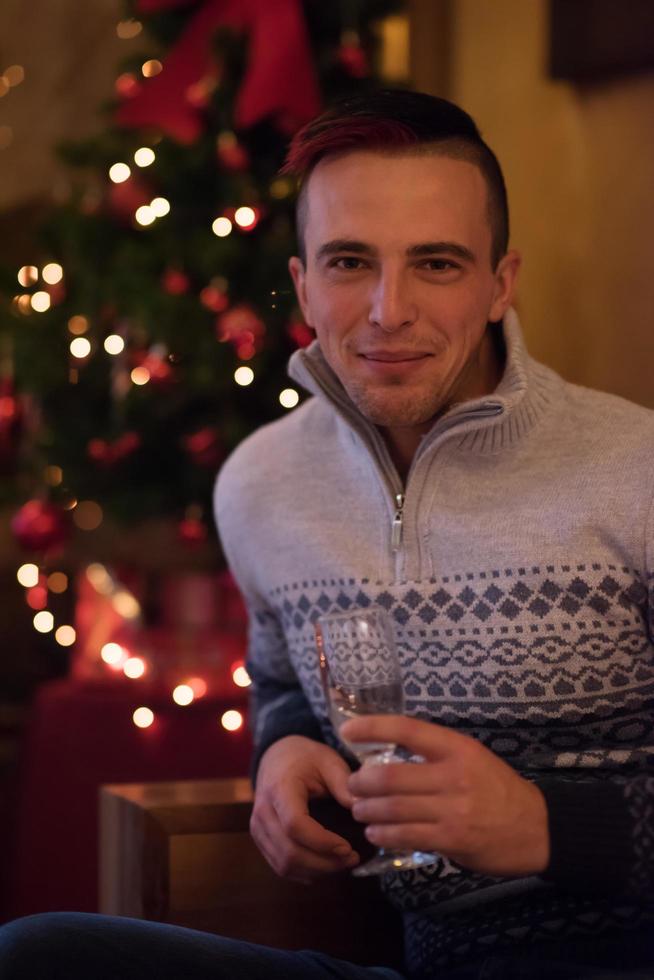 Happy young man with a glass of champagne photo